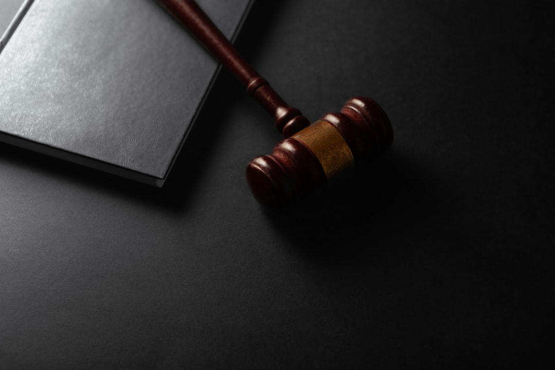 PATTERN assessment — Wooden gavel resting on a dark surface next to book